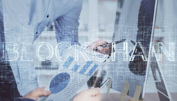 How your old system can adopt to blockchain technology | tycoonstory media Business professionals analyzing data with a focus on blockchain development, highlighting the potential of integrating blockchain technology into existing systems.