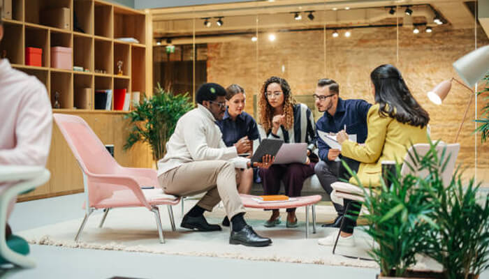 Infrastructure integrity | tycoonstory media A diverse group of professionals collaborating in a modern office setting, embodying the dynamic team effort behind a startup growth engine, driving innovation and success.