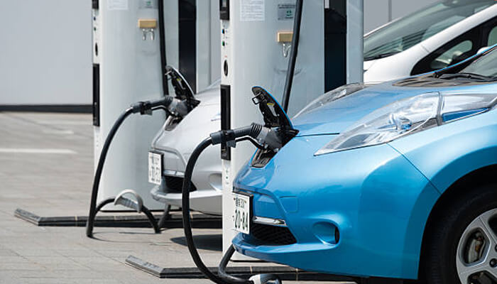 Integrating charging stations with digital tools | tycoonstory media Electric cars being charged at electric car charging stations, highlighting the convenience and accessibility of charging infrastructure for everyday use.