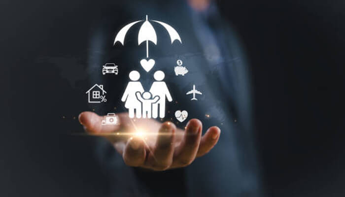 Key benefits of a family floater plan | tycoonstory media An image showing a hand holding icons representing various insurance aspects like health, home, car, and travel, with a family under an umbrella, symbolizing family floater plans for comprehensive coverage.