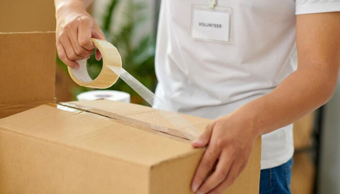 Packaging as the first touchpoint | tycoonstory media Online shopping experience packaging as the first touchpoint showing secure box sealing and careful product preparation for delivery