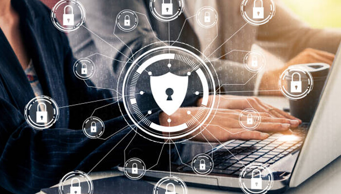 Preparing enterprise security for the quantum era | tycoonstory media Professionals working on a laptop with a digital security interface, highlighting the importance of enterprise security in the quantum computing era with lock icons symbolizing data protection.