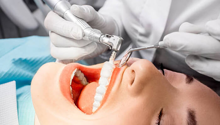 Professional teeth cleaning | tycoonstory media Professional teeth cleaning during a regular dental check-up, showcasing the dental tools used for cleaning and ensuring oral health. "