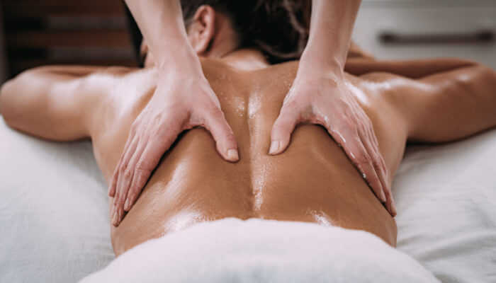 R | tycoonstory media A person receiving a relaxing back massage, highlighting the importance of liability insurance for massage therapists to cover potential risks during sessions.