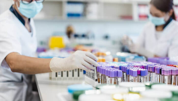 Request samples before committing | tycoonstory media A lab technician handling test tubes, demonstrating the importance of using quality lab supplies to ensure accurate results and maintain safety in the laboratory.