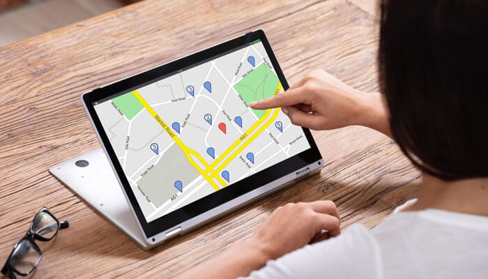 Road map consulting | tycoonstory media A person using a tablet to explore mapping software, symbolizing the strategic planning and location-based services offered by road map consulting, a gsa consultant for small businesses.