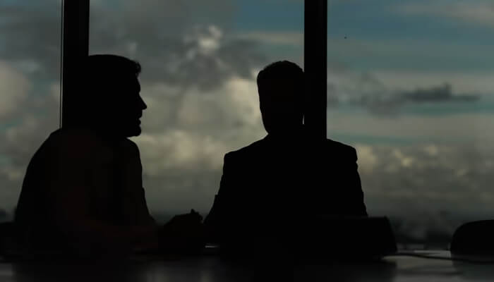 The gap is a translation problem | tycoonstory media Silhouettes of two professionals in a business meeting, possibly discussing strategies or solutions, reflecting the type of insightful conversations justin fulcher advocates.