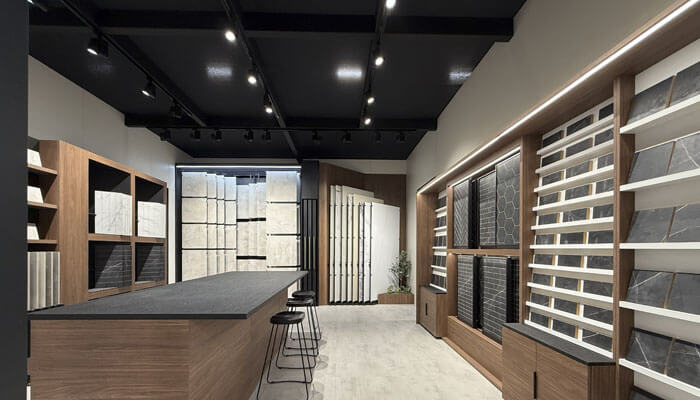 Modern showrooms function | tycoonstory media A modern showroom in the uk ceramic sector showcasing tile displays, blending industrial design and ergonomics to create an engaging and functional space for clients.