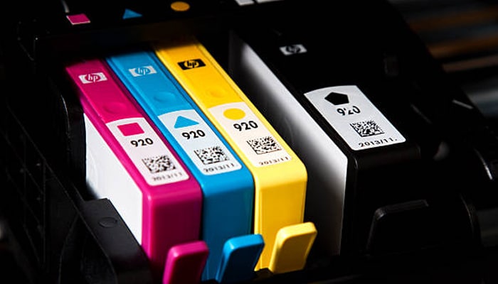 Untitled-1 | tycoonstory media Close-up of color hp ink cartridges (cyan, magenta, yellow, black) installed in printer for high-quality printing.