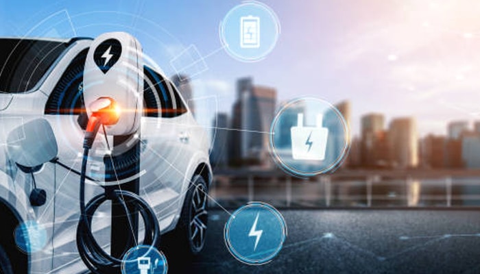 Untitled-1 | tycoonstory media Electric vehicles charging in smart city with digital icons showing connected mobility and energy ecosystem.