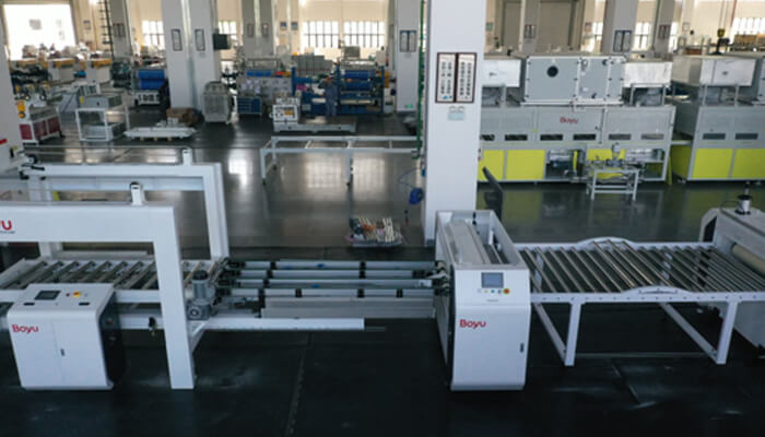 2 4 | tycoonstory media Wide view of an industrial production line with conveyor belts and automated equipment in a spacious factory floor