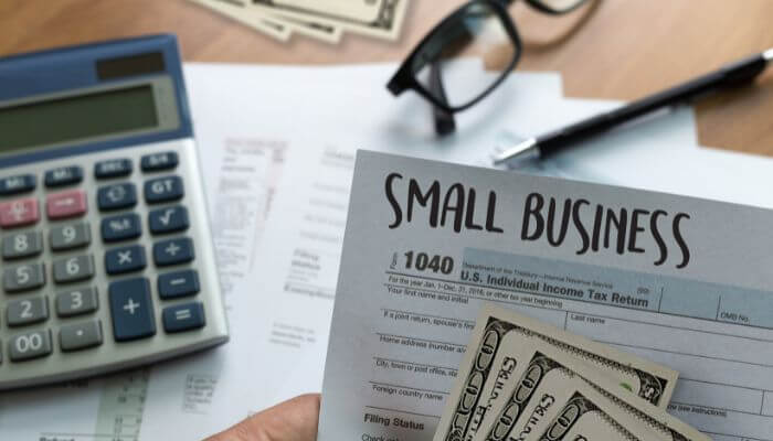 Advantages and disadvantages of factoring for small businesses 1 | tycoonstory media Small business financial paperwork showing the advantages and disadvantages of factoring for working capital and invoice financing