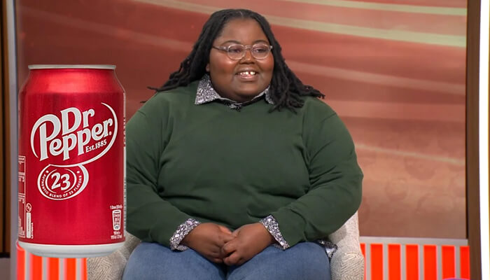 Dr pepper – tiktok creator jingle | tycoonstory media Dr pepper – tiktok creator jingle featuring a smiling content creator in a green sweater, representing successful pr campaigns for the brand.