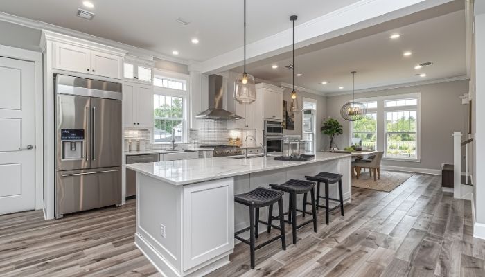 Energy use and operating cost | tycoonstory media Commercial grade kitchen design with stainless appliances, island seating, and modern residential finishes