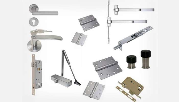 Finding quality commercial door products for door repair and installation projects 1 | tycoonstory media Assorted metal door hardware parts, including handles, hinges, locks, strike plates, and a door closer.