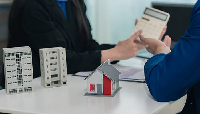 Conveyancing solicitors in london | tycoonstory media Property buyers reviewing documents and financial details during london property purchases, highlighting legal checks and conveyancing processes.