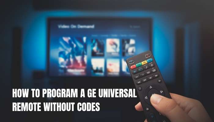 Ge universal remote codes 1 | tycoonstory media Hand holding a tv remote toward a blurred screen displaying streaming apps; text overlay reads'How to program a GE universal remote without codes'