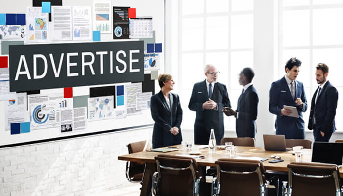 Efficient budget allocation | tycoonstory media Multi-channel advertising concept showing digital icons growing from a tablet for coordinated online campaign planning.