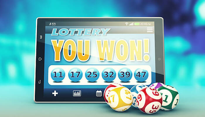 Claiming prizes | tycoonstory media Online lottery games winning screen on a tablet with lottery balls, showing digital jackpot results and number selection.