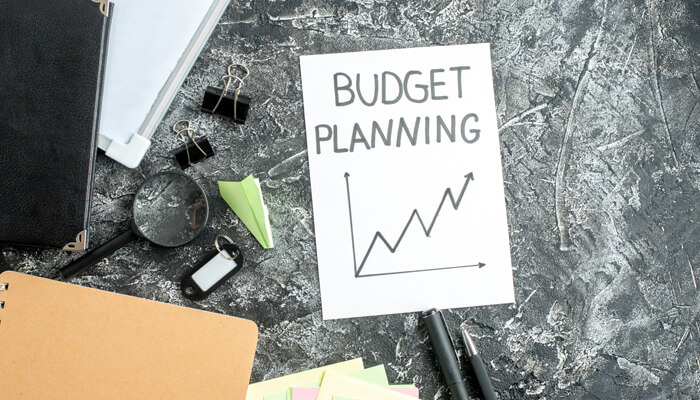 Annual budget planning becomes challenging | tycoonstory media A close-up of a budget planning sheet, with a rising graph, representing the importance of value-driven tax structures in managing finances effectively.