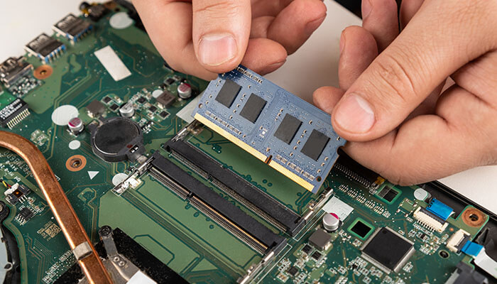 Hardware malfunctions - tycoonstory | tycoonstory media Technician installing ram on a motherboard illustrating hardware-related causes behind hcs 411gits error codes such as memory failure, system instability, and performance errors in computing systems