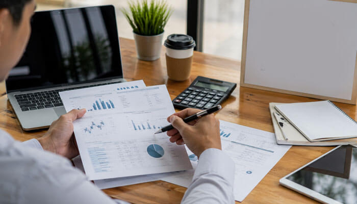 How much does accounting for startups cost - tycoonstory | tycoonstory media Accounting for startups workspace with financial charts, calculator, laptop, and business reports showing startup cost and cash flow planning.