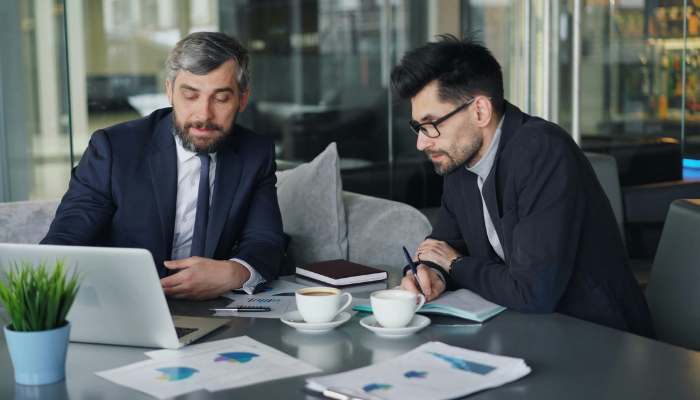 Investor 1 | tycoonstory media Business professionals reviewing financial reports and market data, demonstrating strategic decision-making in modern investing.