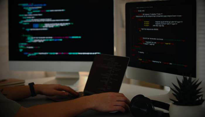 Mysql queries 2 | tycoonstory media Software developer optimizing sql code on multiple screens while working on mysql query performance and database optimization.