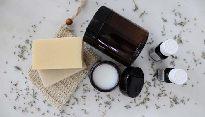 Understanding container design | tycoonstory media Natural cosmetic products including soap, cream, and essential oils stored in protective containers for quality and long-term use.