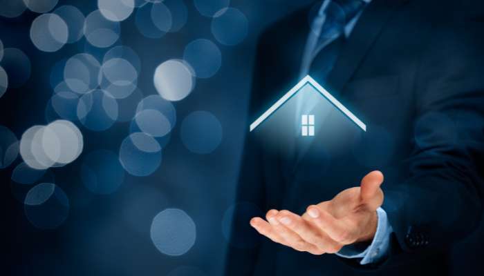 What makes a commercial property attractive to long-term tenants 2 | tycoonstory media Hand open under a glowing house icon, symbolizing home protection or real estate services.