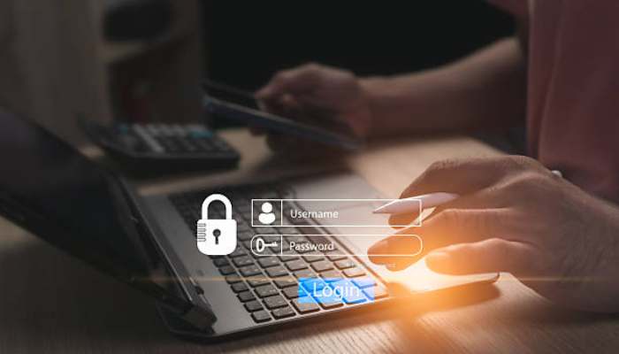 6 digital security habits every remote pro needs 1 | tycoonstory media Overlay of a login form with username and password fields and a glowing login button on a laptop touchpad, emphasizing security.
