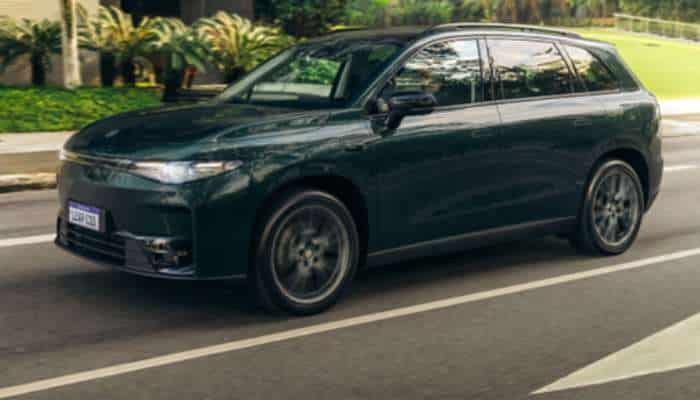 Best chinese electric cars in europe 2026 2 | tycoonstory media Dark green suv driving on a suburban street with greenery in the background.