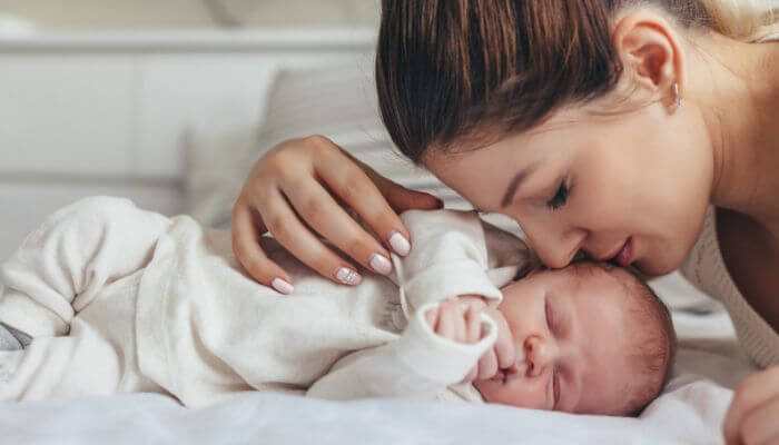 - Startup Stride Tips and Tricks Impocoolmom showing a loving mother caring for her sleeping baby as part of smart mom hacks for easier daily life