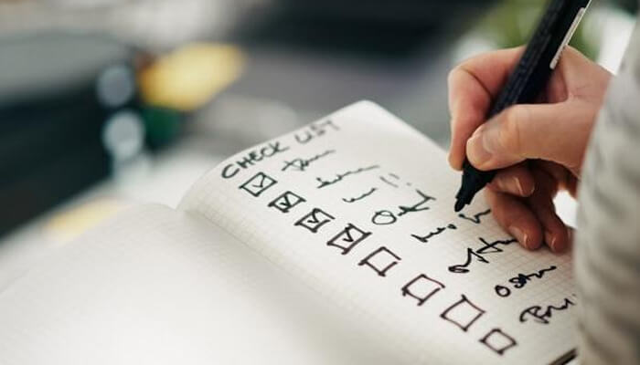 Fit for common adelaide property finance decisions - tycoonstory | tycoonstory media Mortgage broker in adelaide concept showing a hand writing a mortgage checklist in a notebook, representing structured loan preparation, document verification, and step-by-step home loan planning used by brokers to help buyers assess eligibility, compare lending options, and meet australian property finance requirements.