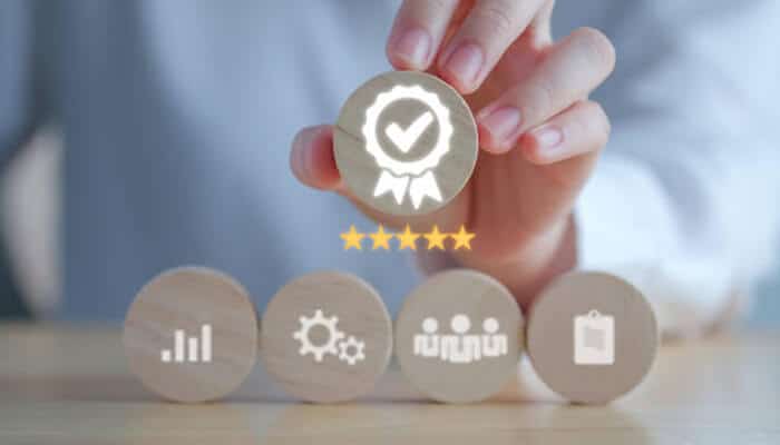 Equality, diversity and inclusion - tycoonstory | tycoonstory media Hand holding a quality badge with rating stars above a row of business icons representing analytics, strategy, people, and performance, illustrating how equality, diversity and inclusion strengthens reputation, talent attraction, and customer reach in modern organisations.