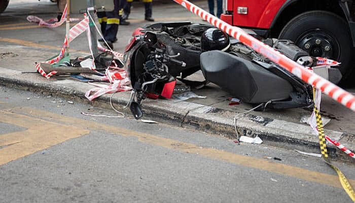 Why motorcycle accidents are different | tycoonstory media Damaged motorcycle at a secured crash scene, illustrating why lawyers in harrisburg handle severe injury claims involving vulnerable riders.