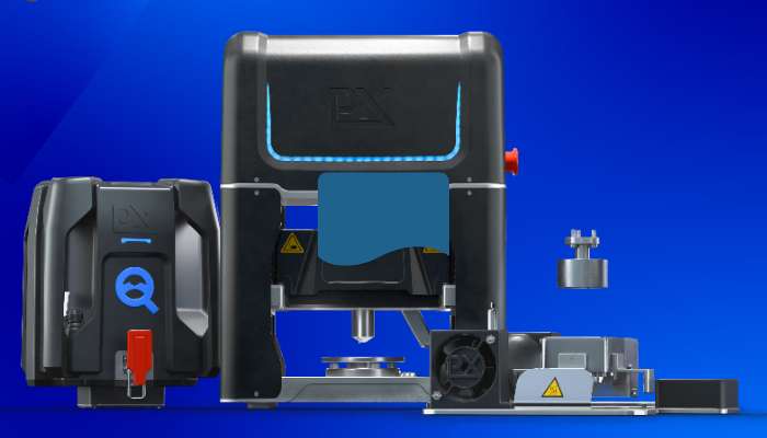 How faster stress-strain testing cuts metals costs 1 | tycoonstory media 3d-rendered industrial machine setup with a large black unit featuring blue accents and a smaller control module on the left, on a blue background.