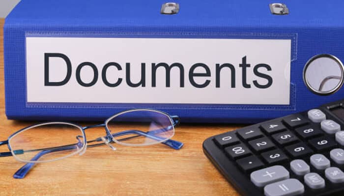 Why is documentation important in property division cases? | tycoonstory media Property division documents, calculator, and eyeglasses representing the financial records needed to identify, value, and divide marital assets and debts.