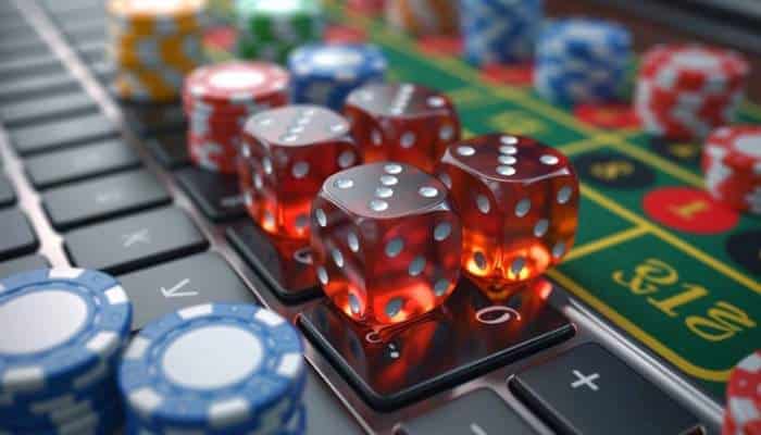 Online casino industry 1 | tycoonstory media Online casino gaming setup featuring dice, poker chips, and digital casino elements for virtual gameplay.
