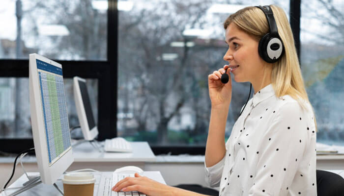 What call tracking actually gives you - tycoonstory | tycoonstory media Customer service representative wearing a headset at a computer in an office