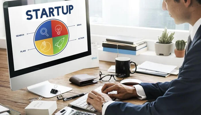 Subscription startups need extra billing discipline - tycoonstory | tycoonstory media Desk workspace with an imac showing a four-quadrant startup idea wheel and the word startup