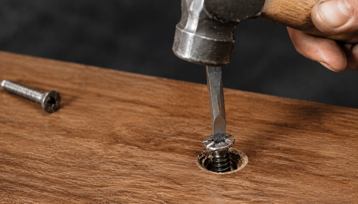 Tap a flathead screwdriver into the head generate - tycoonstory | tycoonstory media How to remove a stripped screw by tapping a flathead screwdriver into the damaged screw head with a hammer