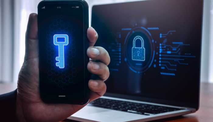 Two-factor authentication 2 | tycoonstory media What is a two-factor authentication method illustrated with a smartphone security key and encrypted laptop login screen, demonstrating advanced account protection against cyber threats and unauthorized access.