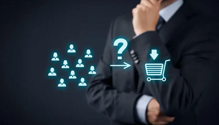 Understand customer behavior more effectively - tycoonstory | tycoonstory media Businessman in a suit considering a funnel from a group of people to a shopping cart icon with a question mark.