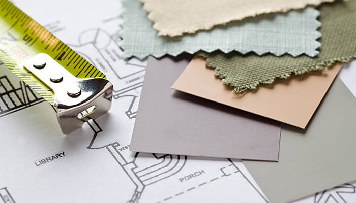 Untitled-1 | tycoonstory media Measuring tape and fabric swatches laid over an architectural floor plan, signaling interior design and space planning