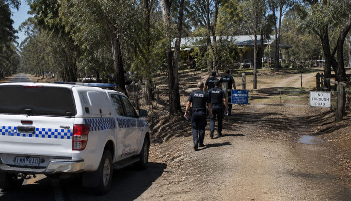 Why did police attend the porepunkah property - tycoonstory | tycoonstory media Who is dezi freeman – police officers approaching a rural property in porepunkah during investigation, with marked vehicles and restricted access signs at the scene of the 2025 incident.