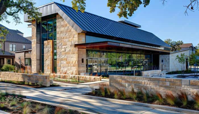 Cornerstone building brands - tycoonstory | tycoonstory media Top home exterior solutions showcasing a modern residential building with premium roofing, stone walls, large windows, and innovative exterior design features