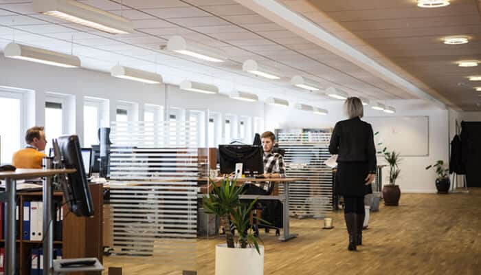 Building long-term enterprise corporate value | tycoonstory media Business credit score concept in a modern office environment showing professionals working at desks, representing long-term enterprise growth, financial stability, and corporate credit health.