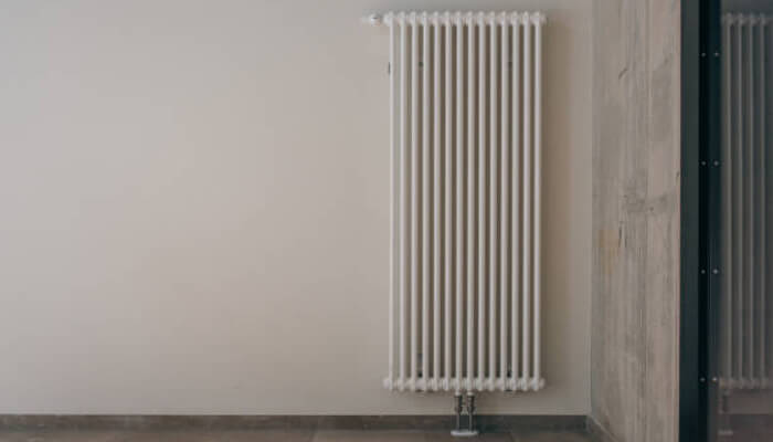 Where do vertical radiators work best? | tycoonstory media Modern home interior featuring vertical radiators installed on a wall for efficient heating and space-saving design.