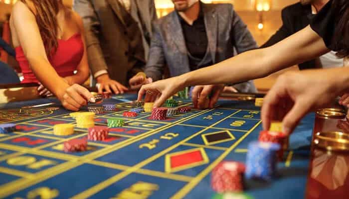 Bitcasino - tycoonstory | tycoonstory media Players placing bets at a live roulette table in one of the top casinos with live table games, showcasing real-time gaming, casino chips, and an authentic live dealer experience.